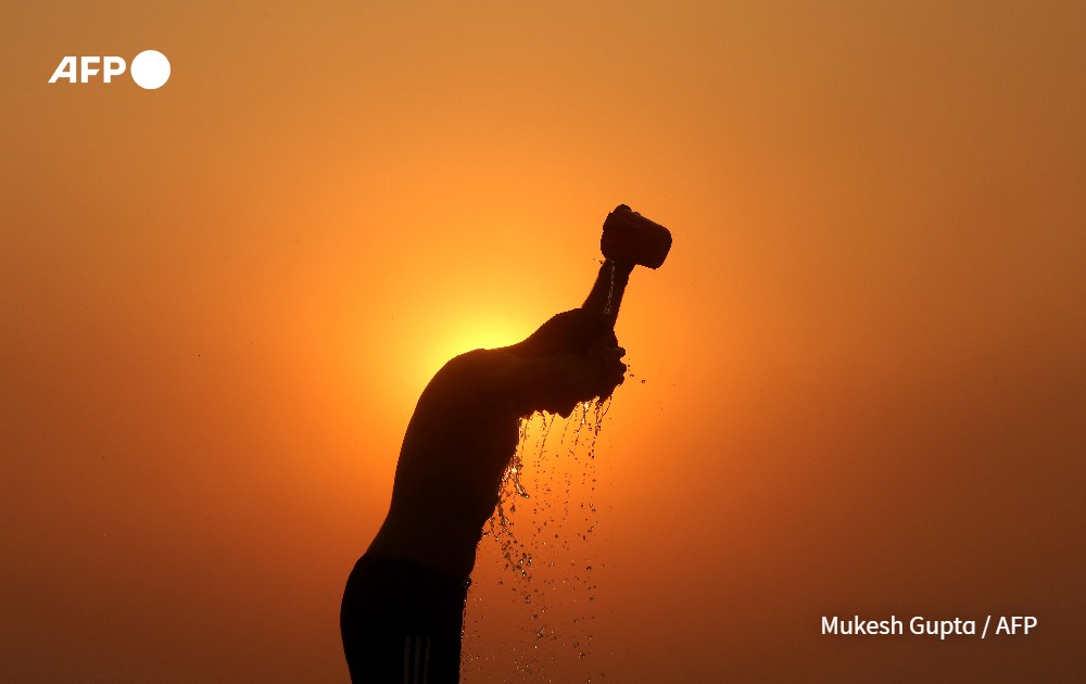 Labourer is silhouetted against the setting sun